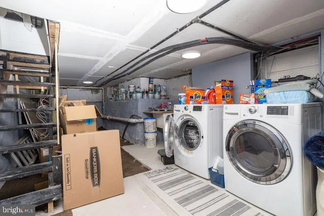 a view of storage and utility room with washer and dryer