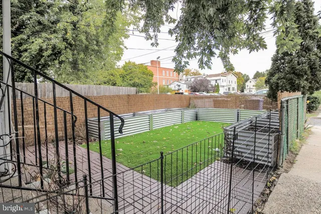 a view of a building with backyard and deck