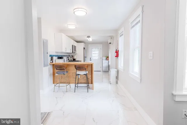 a view of a kitchen with dining table and chairs