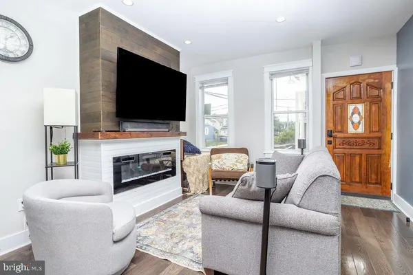 a living room with furniture a fireplace and a flat screen tv
