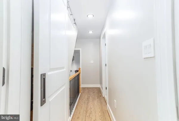 a view of a hallway with a white walls