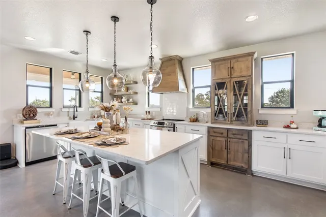 a kitchen with appliances a sink and cabinets