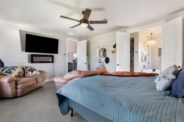 a bedroom with a bed couch and a flat screen tv