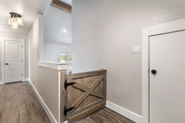 a view of hallway with wooden floor