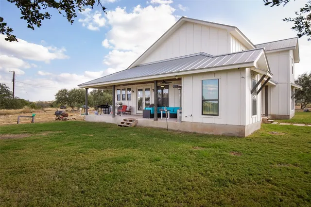 a view of a patio with table and chairs and potted plants