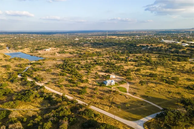 a view of a house next to a yard and a large trees