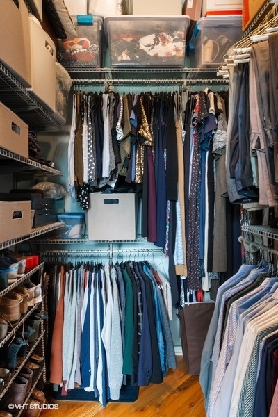 1040 West Adams Street, Unit 336 Chicago, IL 60607 - Photo 12 of 23 a view of walk in closet with clothes and shoes