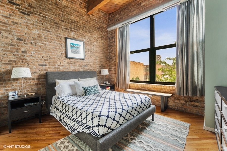 1040 West Adams Street, Unit 336 Chicago, IL 60607 - Photo 13 of 23 a bedroom with a bed and a large window