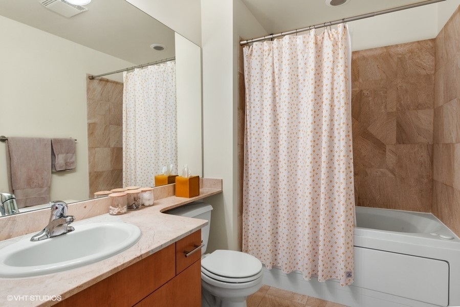 1040 West Adams Street, Unit 336 Chicago, IL 60607 - Photo 14 of 23 a bathroom with a sink a toilet and a mirror