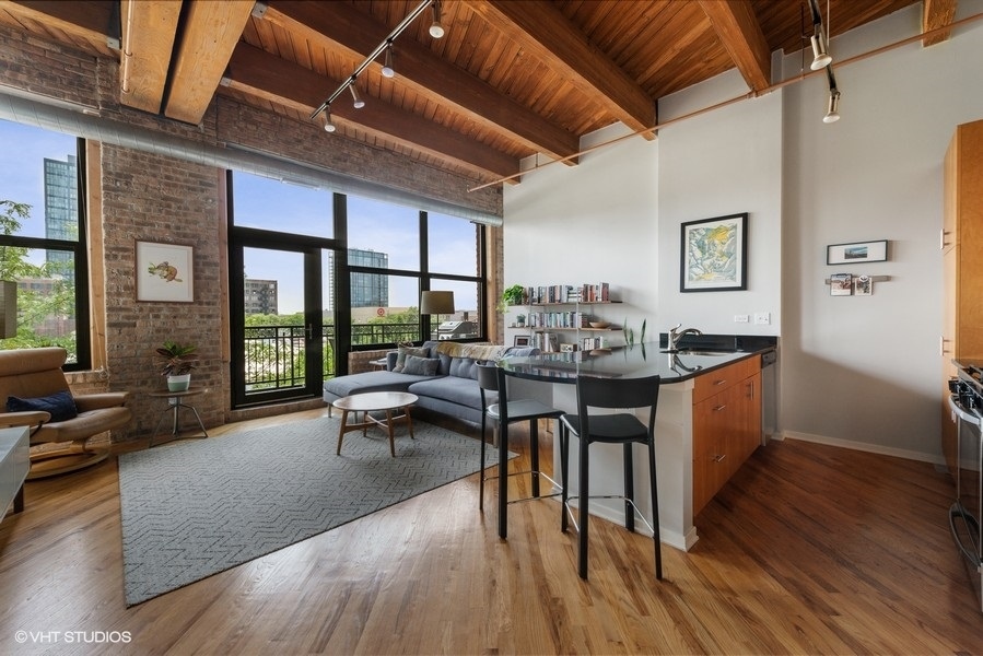 1040 West Adams Street, Unit 336 Chicago, IL 60607 - Photo 10 of 23 a view of a dining room with furniture window and wooden floor