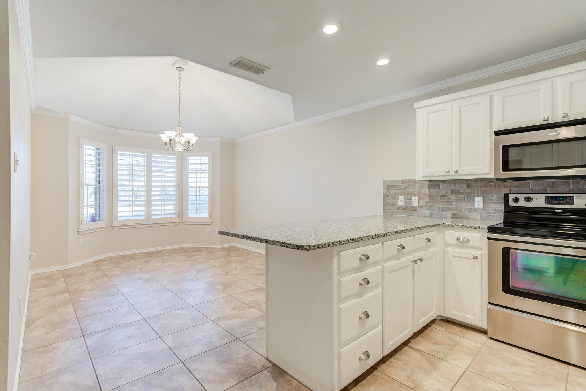 5407 68th Street Lubbock, TX 79424 - Photo 11 of 40 a kitchen with white cabinets and appliances