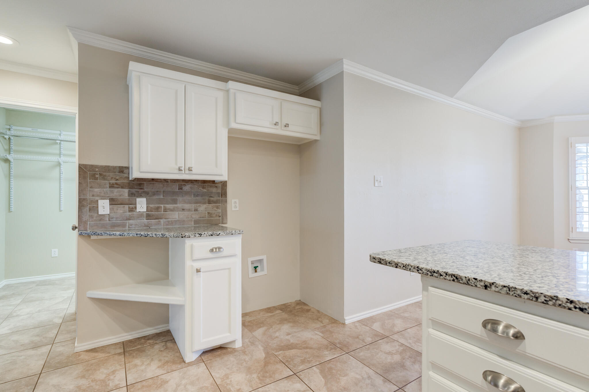 5407 68th Street Lubbock, TX 79424 - Photo 15 of 40 a kitchen with granite countertop white cabinets and white appliances