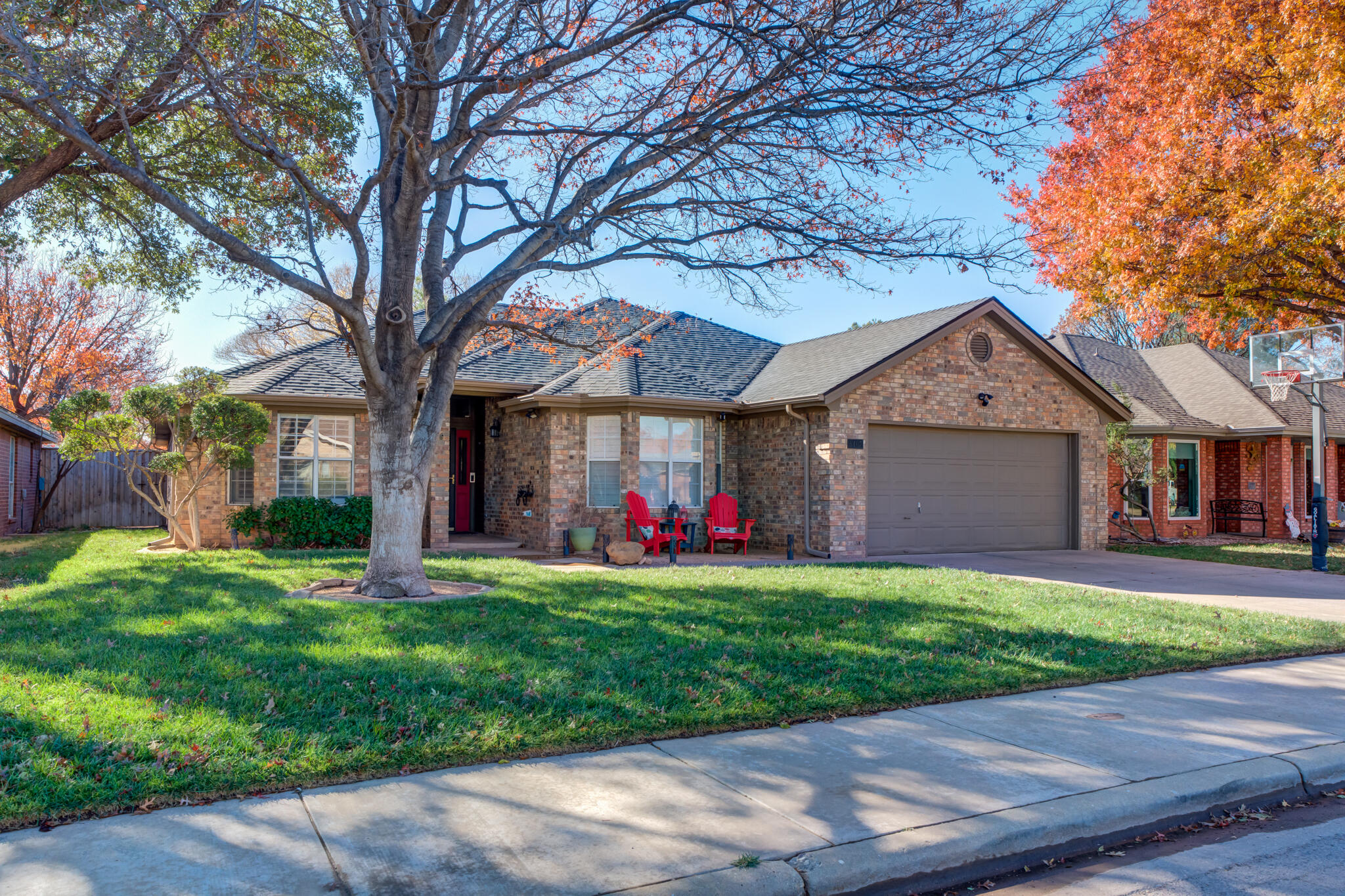 5407 68th Street Lubbock, TX 79424 - Photo 2 of 40 a front view of a house with a yard and garage