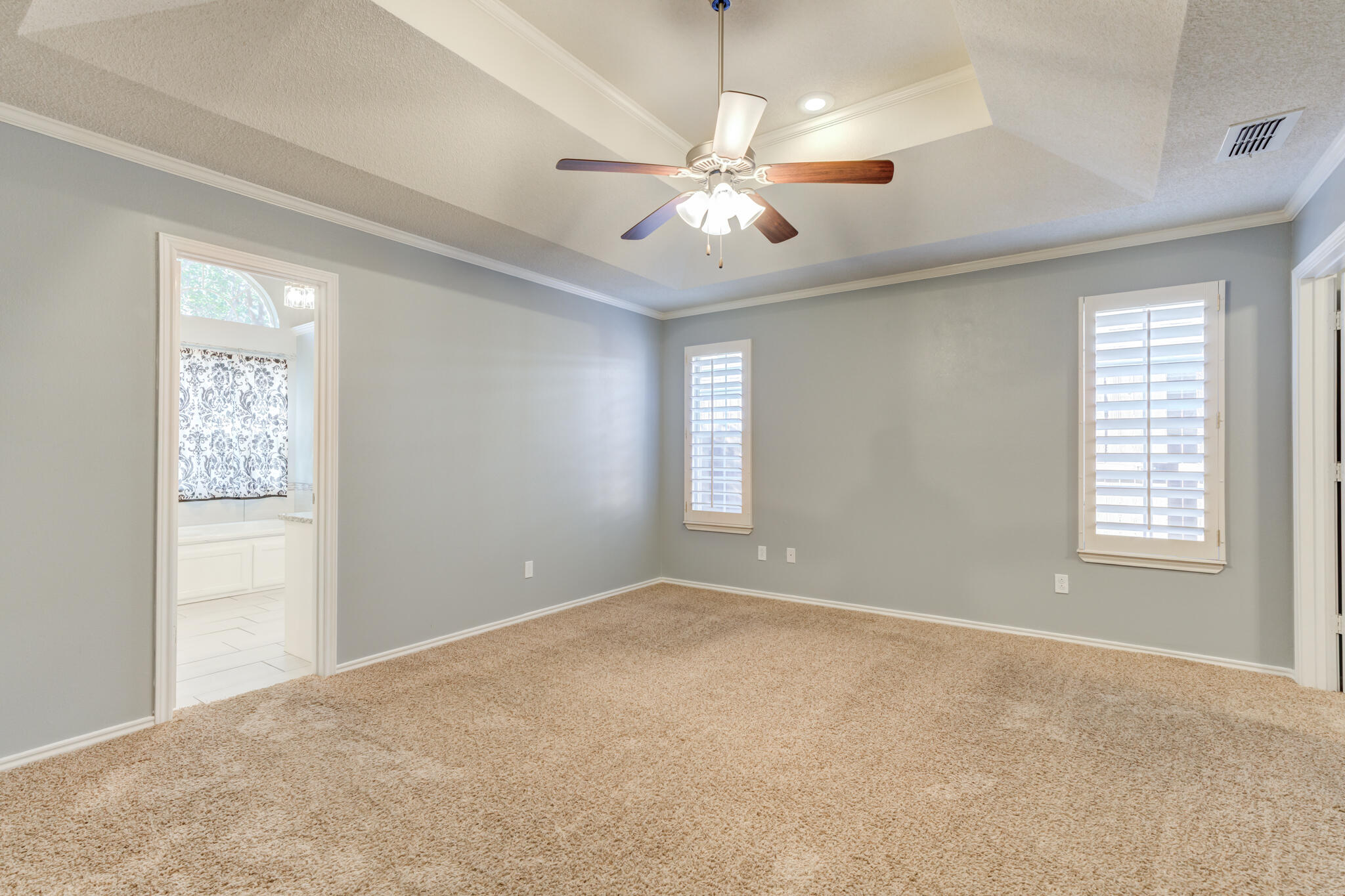 5407 68th Street Lubbock, TX 79424 - Photo 24 of 40 an empty room with windows and fan