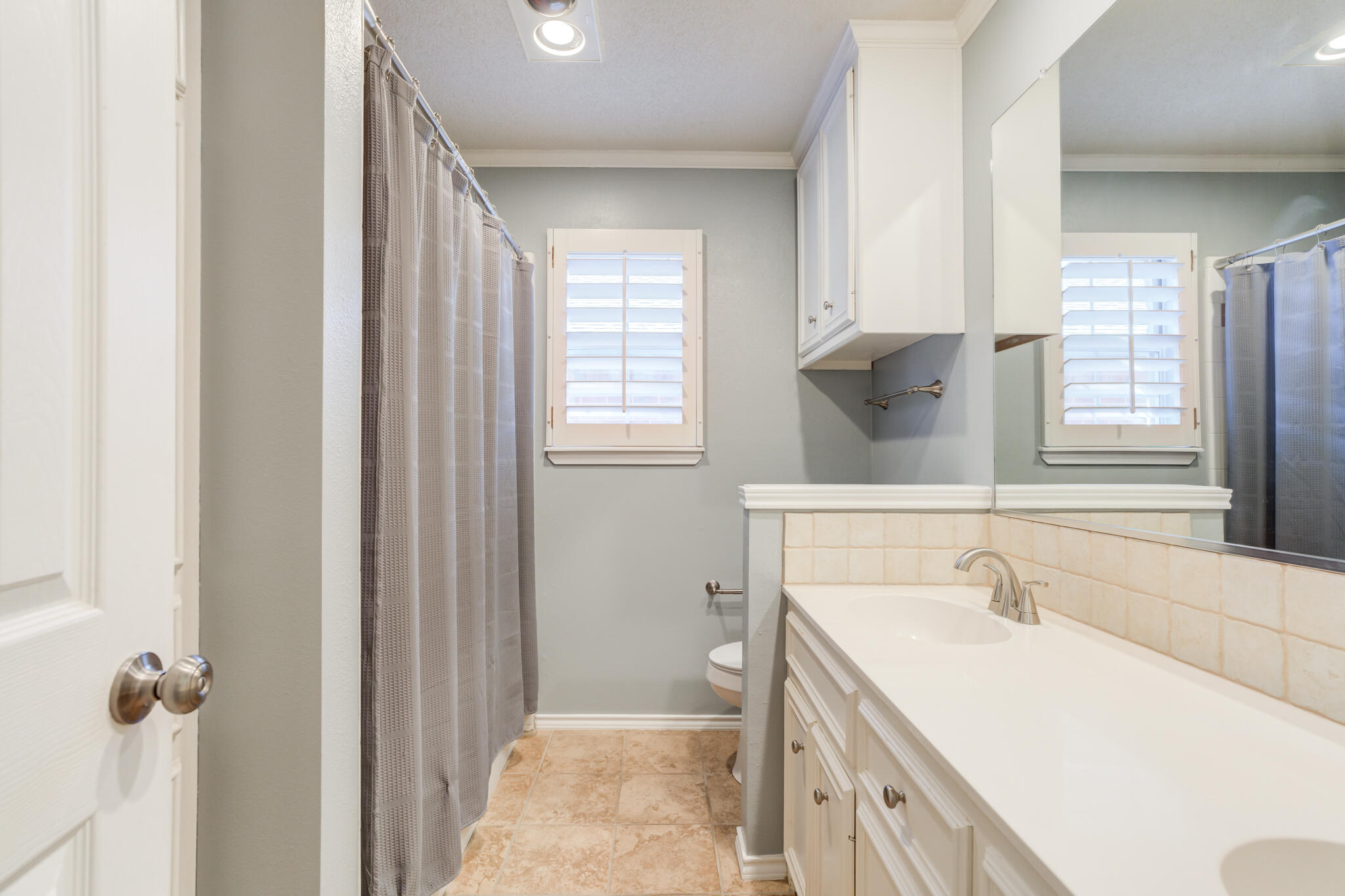 5407 68th Street Lubbock, TX 79424 - Photo 29 of 40 a bathroom with a sink vanity granite tub and shower