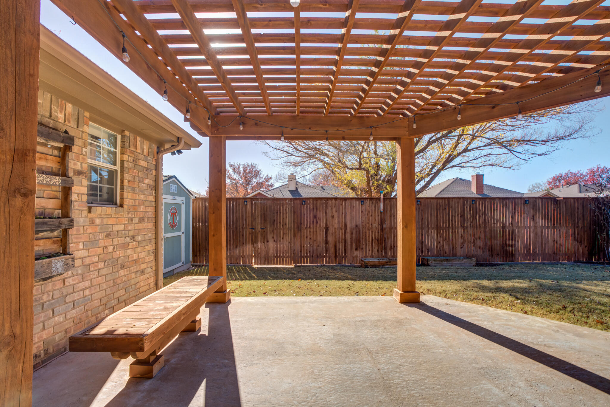 5407 68th Street Lubbock, TX 79424 - Photo 37 of 40 a view of a backyard with a wooden fence