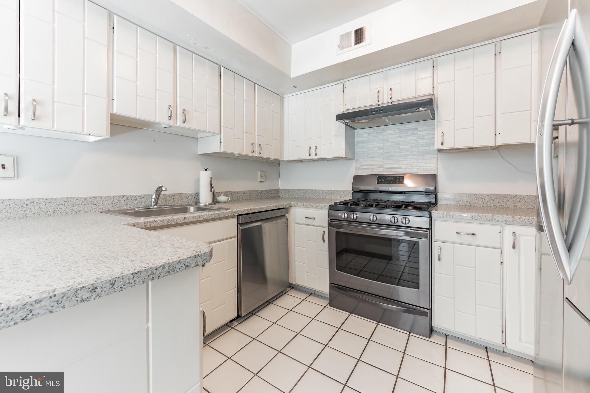 9667 Pine Road Philadelphia, PA 19115 - Photo 11 of 30 a kitchen with cabinets appliances and a sink