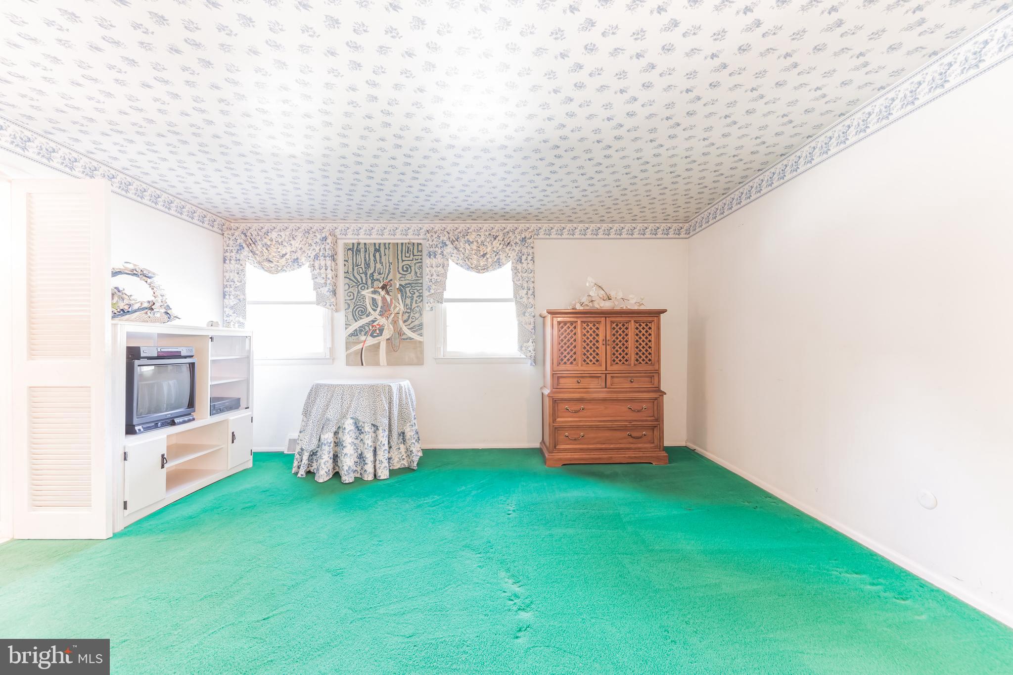9667 Pine Road Philadelphia, PA 19115 - Photo 19 of 30 a view of an empty room with a fireplace and a window