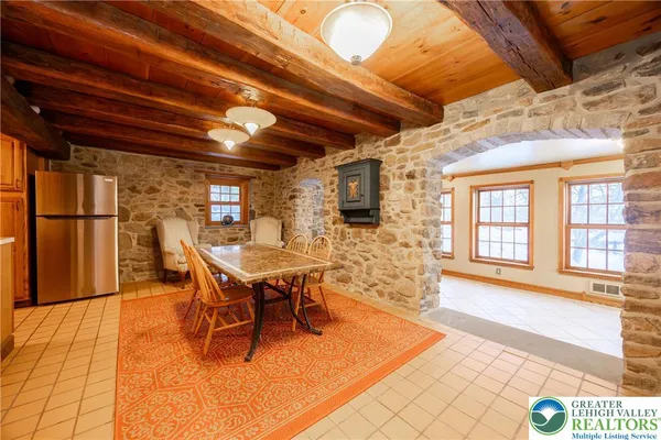 a dining room with furniture and wooden floor