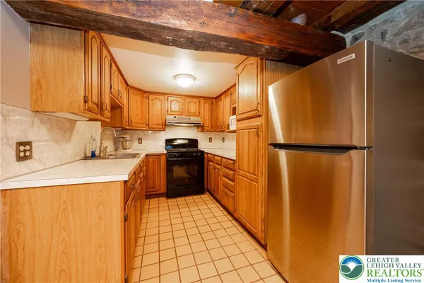 a kitchen with stainless steel appliances a refrigerator and a stove top oven