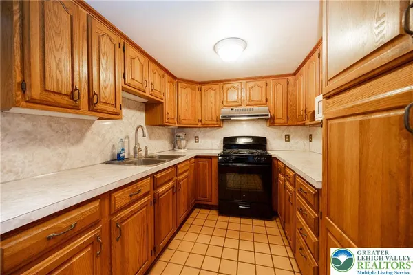 a kitchen with stainless steel appliances granite countertop a stove a sink dishwasher and a refrigerator