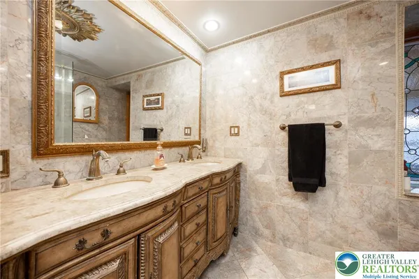 a bathroom with a granite countertop sink mirror and