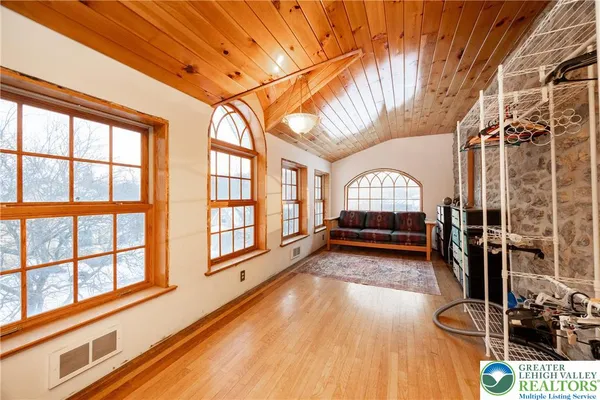 a view of entryway with wooden floor and windows