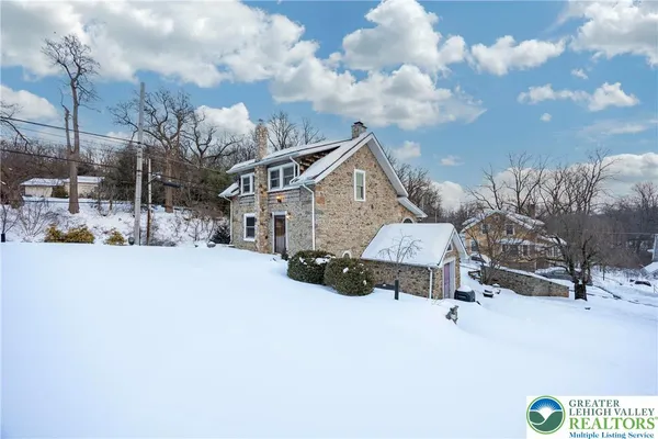 a view of a house with a snow in the yard
