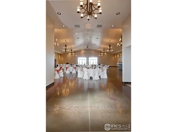 a view of a dining room with furniture and chandelier