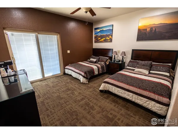 a bedroom with bed and a flat screen tv