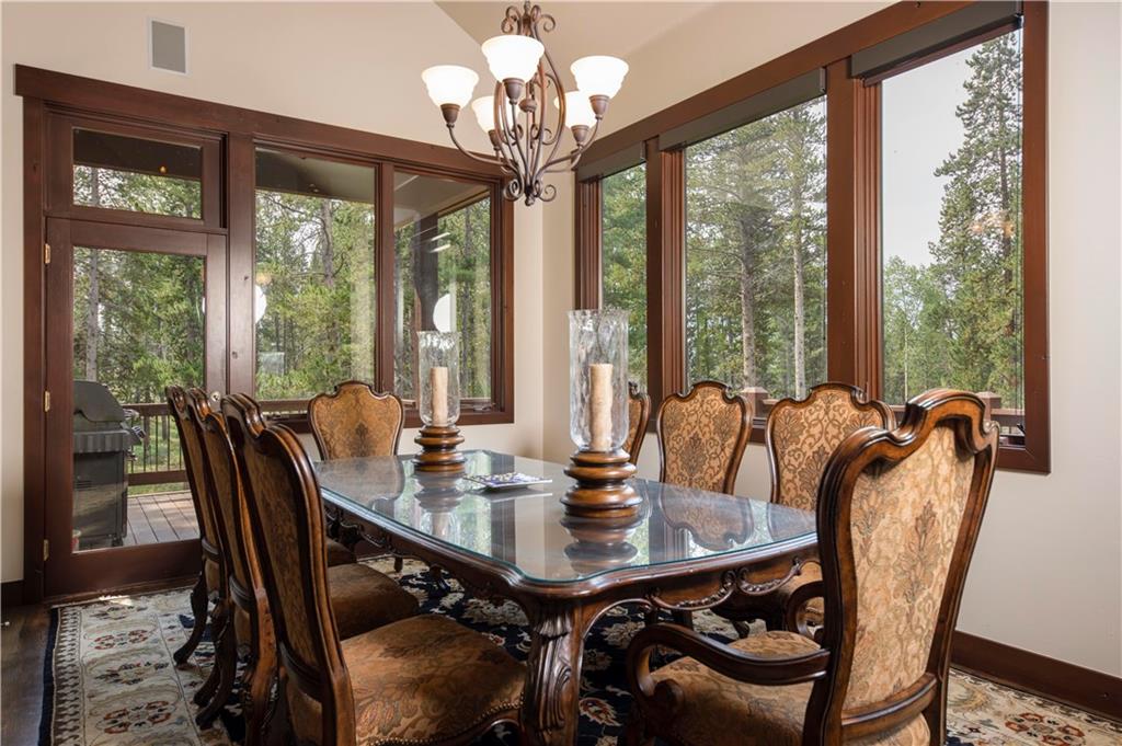 29 Rounds Road Breckenridge, CO 80424 - Photo 9 of 35 a view of a dining room with furniture large windows a chandelier and wooden floor