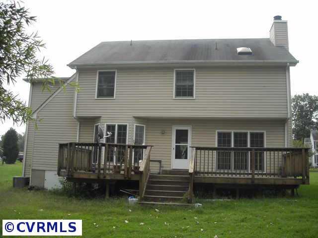 5306 Gatebridge Road Richmond, VA 23234 - Photo 2 of 4 a view of a house with a wooden deck and a yard