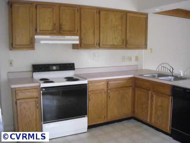 5306 Gatebridge Road Richmond, VA 23234 - Photo 3 of 4 a kitchen with a sink stove and cabinets