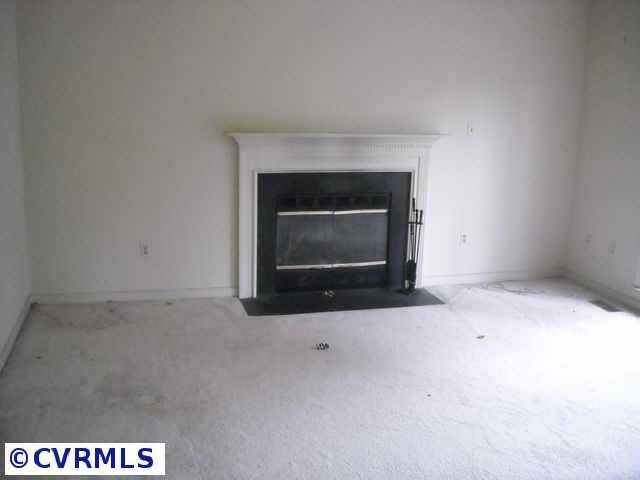 5306 Gatebridge Road Richmond, VA 23234 - Photo 4 of 4 a fireplace with a hallway