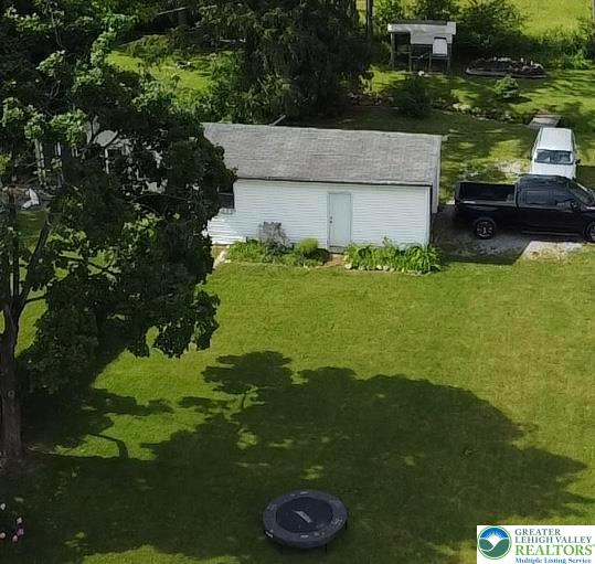 7241 Decatur Street New Tripoli, PA 18066 - Photo 31 of 36 A well-maintained lawn surrounds a charming outbuilding with mature trees casting dappled shade.