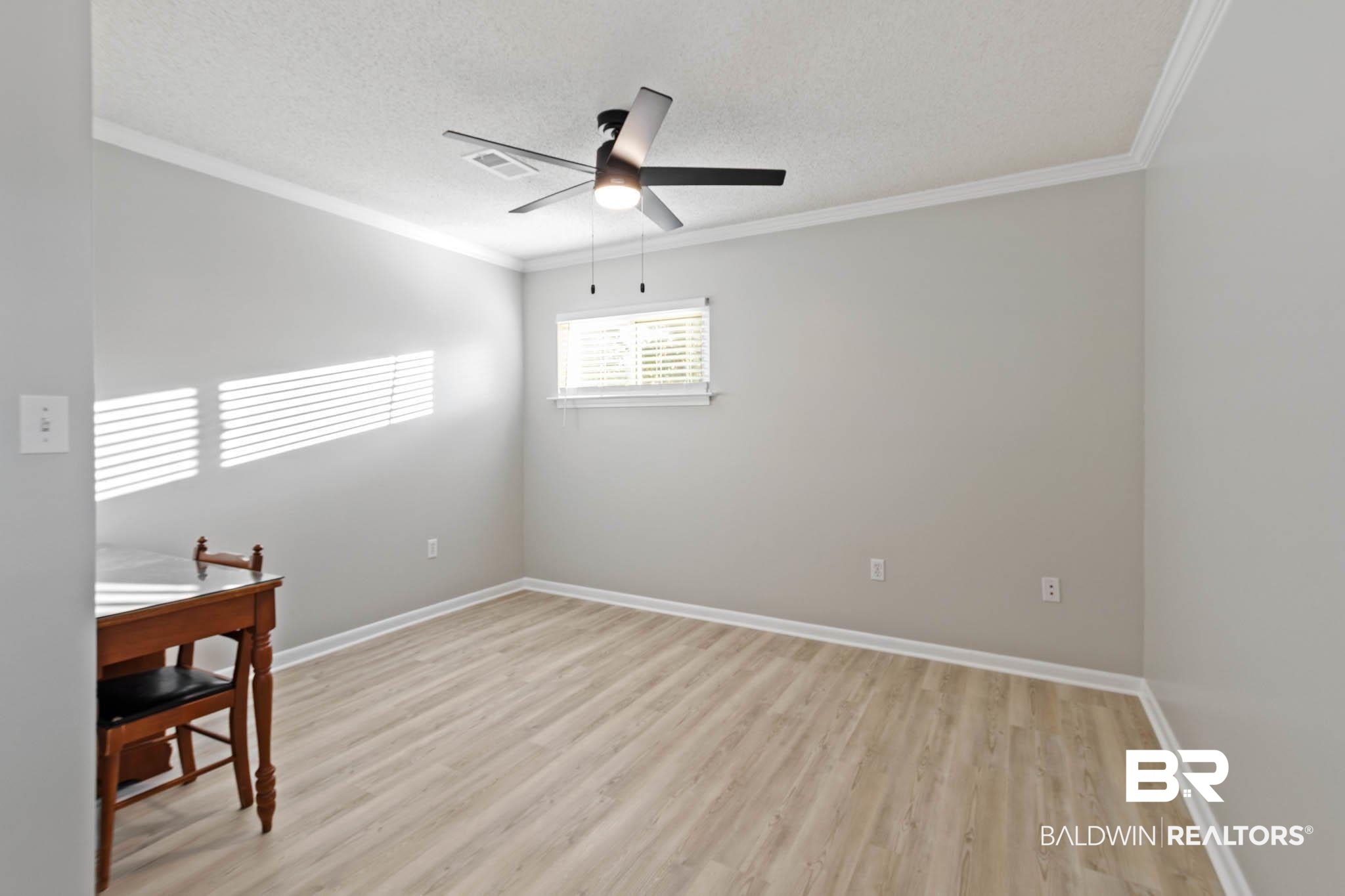 608 Southern Way Daphne, AL 36527 - Photo 25 of 35 Spare room with light wood finished floors, a textured ceiling, ornamental molding, and a ceiling fan