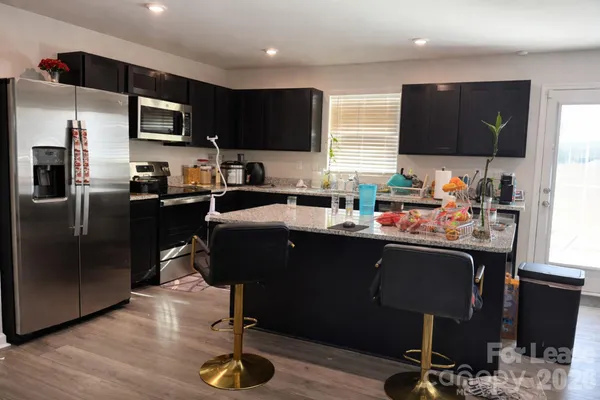 a kitchen with a sink appliances and cabinets