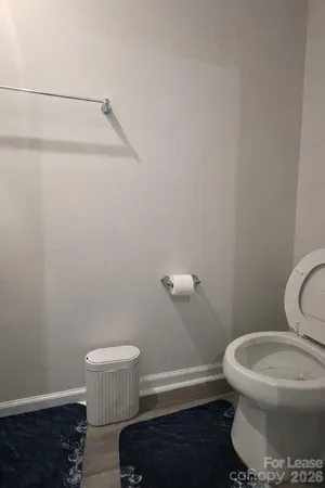 a white toilet sitting next to a shower