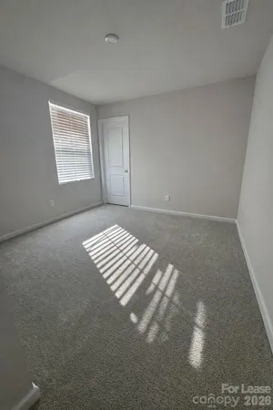 a view of an empty room with windows