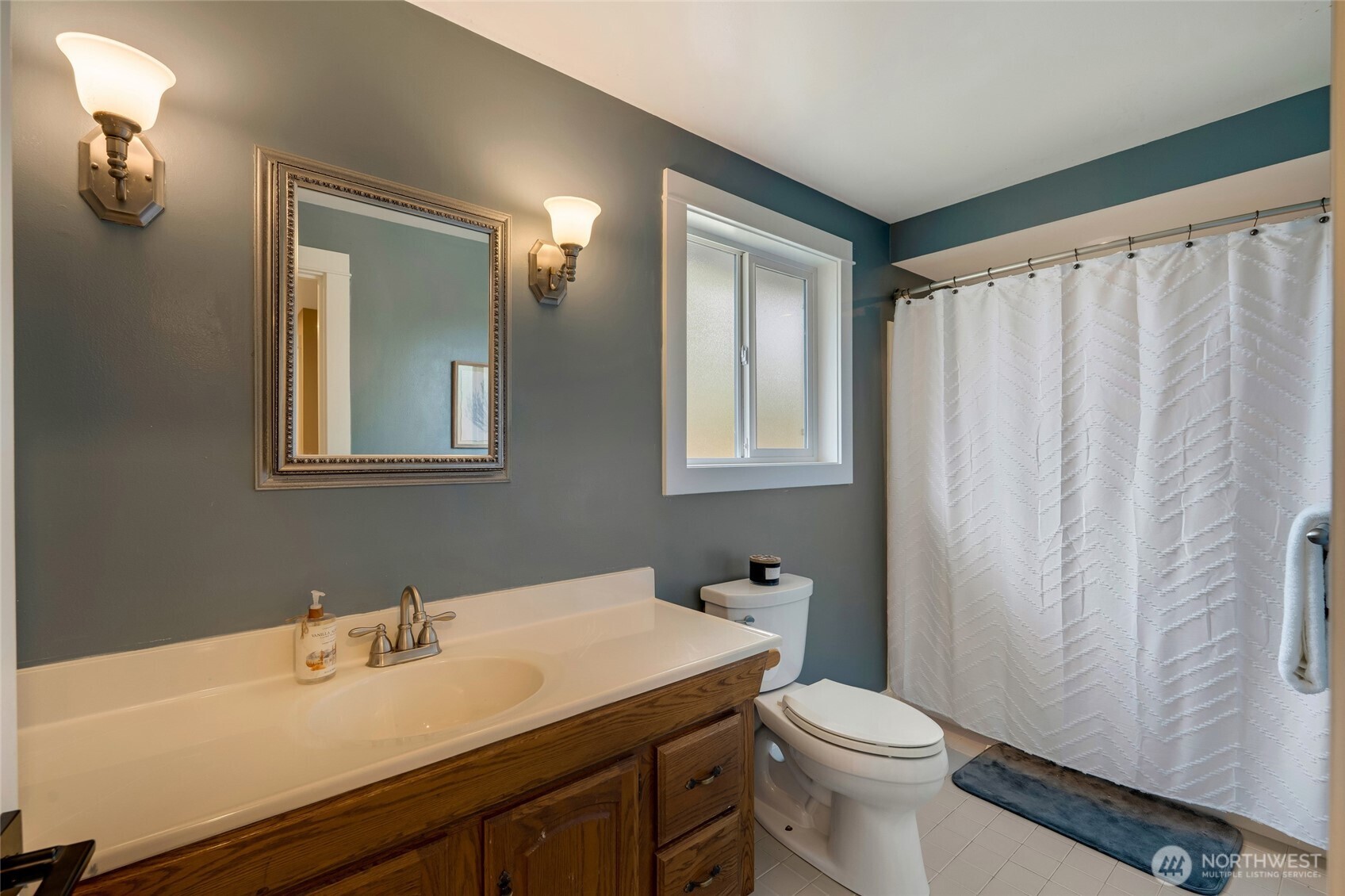 8804 209th Place Southwest Edmonds, WA 98026 - Photo 15 of 35 a bathroom with a sink a toilet and mirror