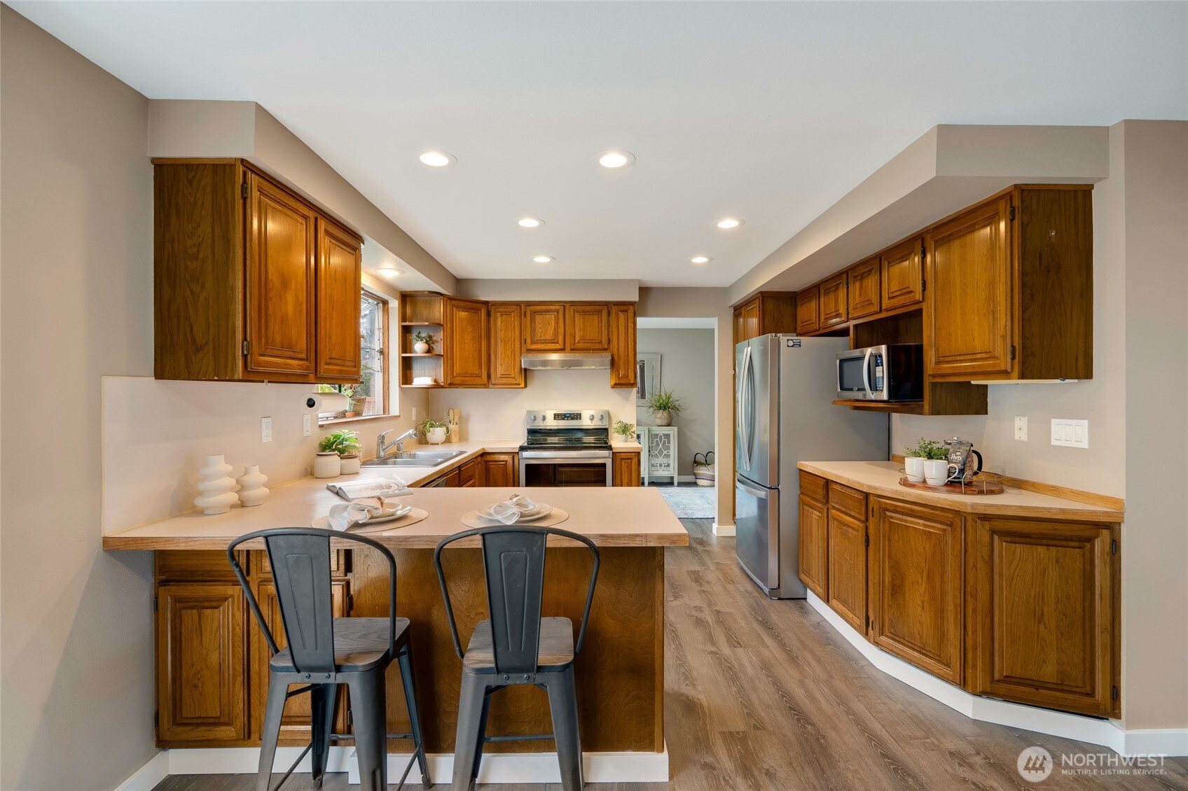 8804 209th Place Southwest Edmonds, WA 98026 - Photo 9 of 35 a kitchen with stainless steel appliances granite countertop a table chairs sink refrigerator and cabinets