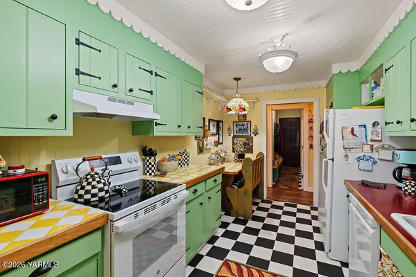 a kitchen with stainless steel appliances kitchen island granite countertop a sink and cabinets