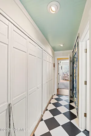 a view of a bathroom with a checkered floor and a window