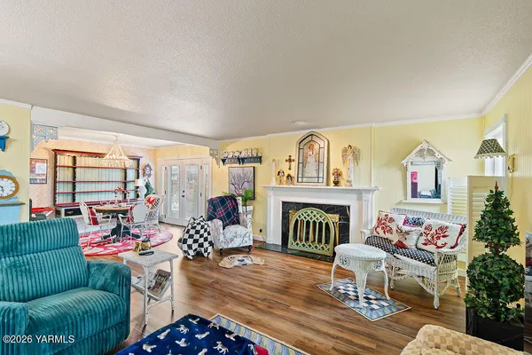 a living room with furniture a fireplace and a potted plant