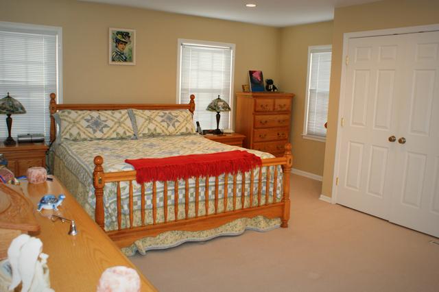 5N565 Billy Burns Road Wayne, IL 60184 - Photo 12 of 25 a bedroom with a bed and dresser with mirror