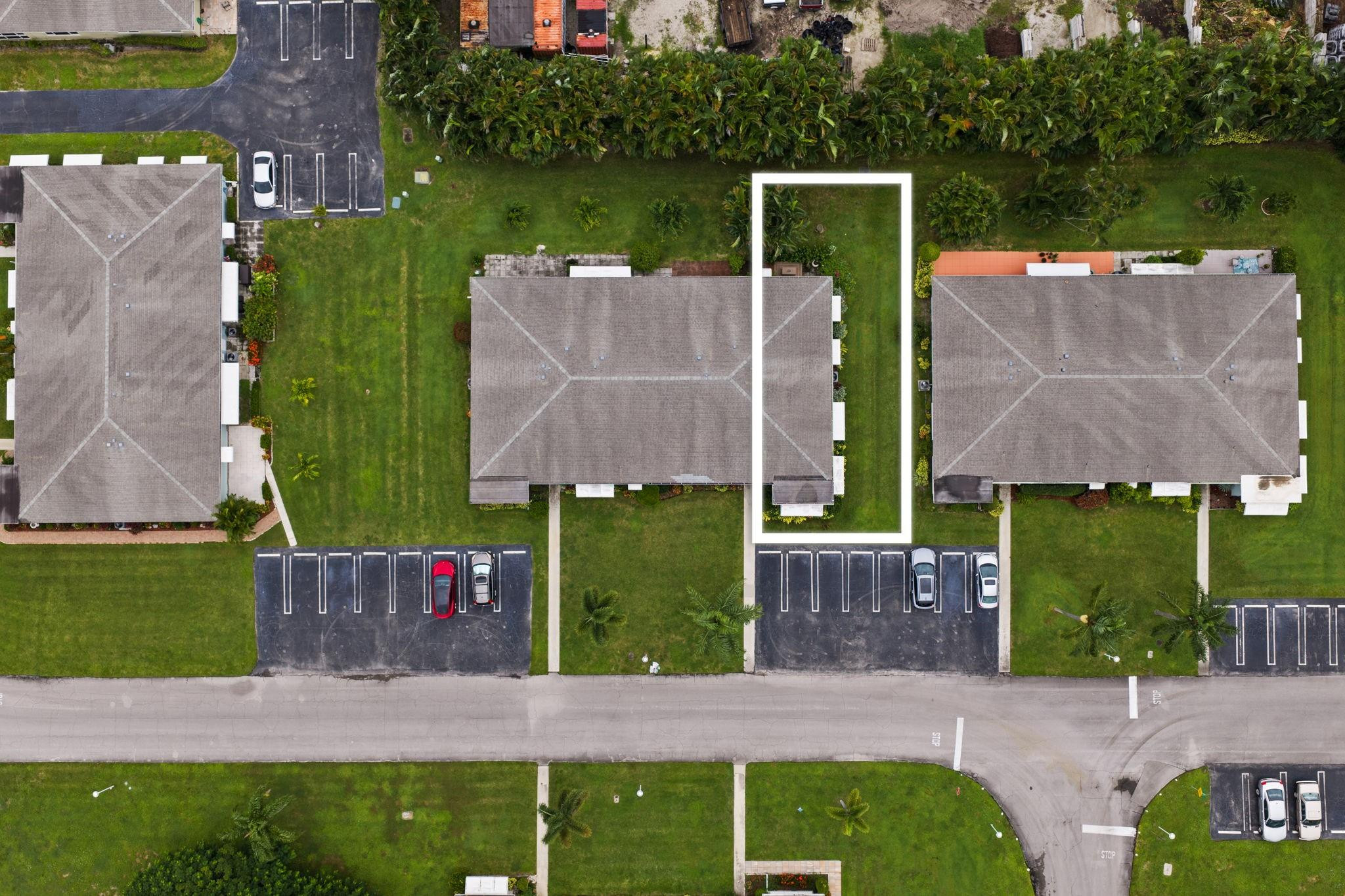 an aerial view of a house with a garden and yard