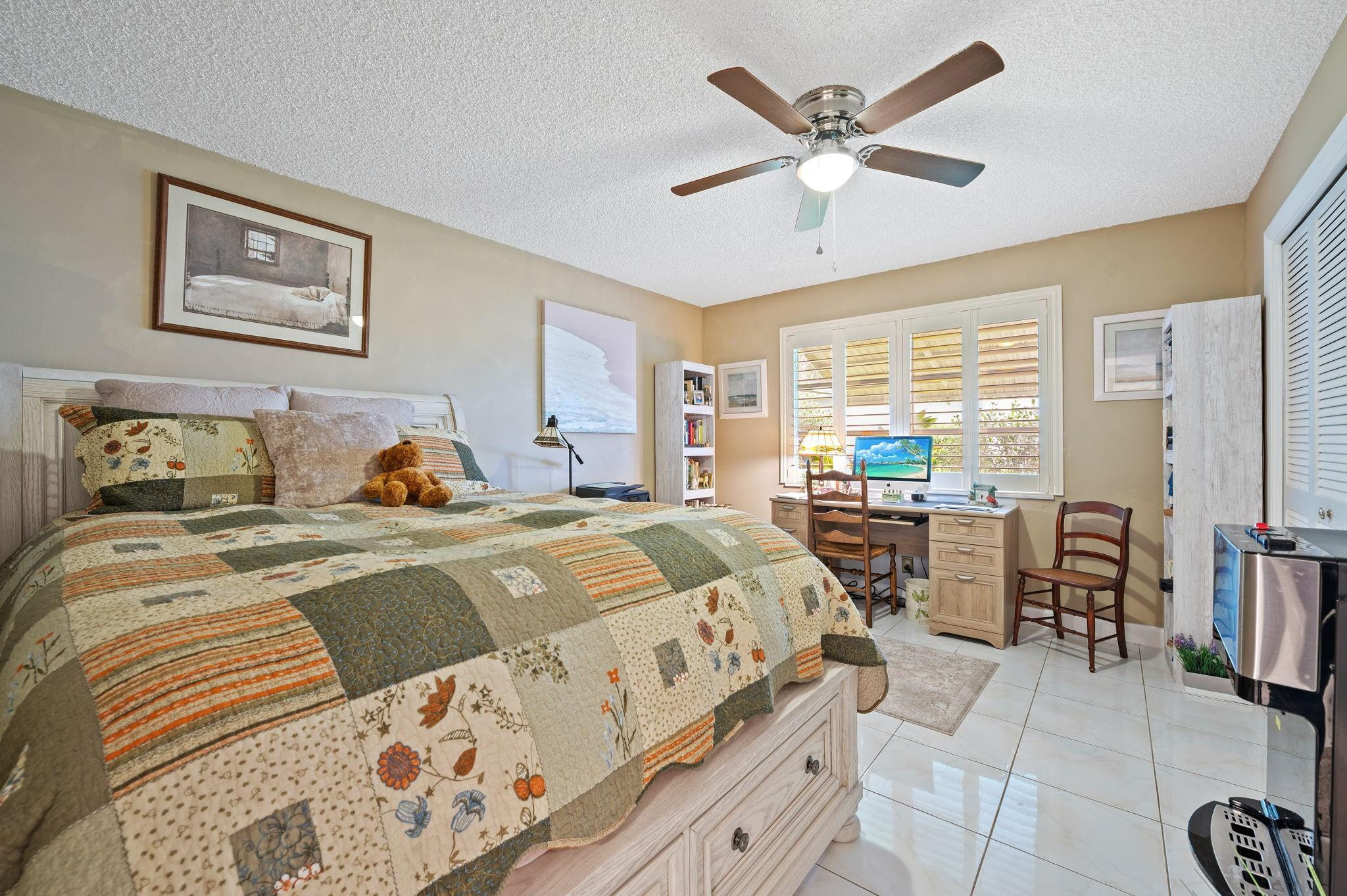 152 High Point Boulevard, Unit D Delray Beach, FL 33445 - Photo 18 of 34 a bedroom with a bed and wooden floor
