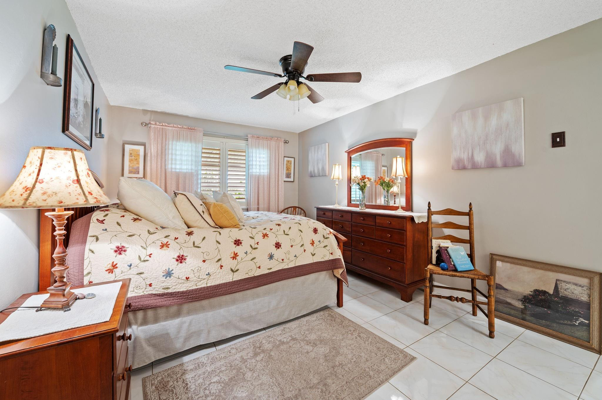 152 High Point Boulevard, Unit D Delray Beach, FL 33445 - Photo 23 of 34 a bedroom with a bed and a chandelier