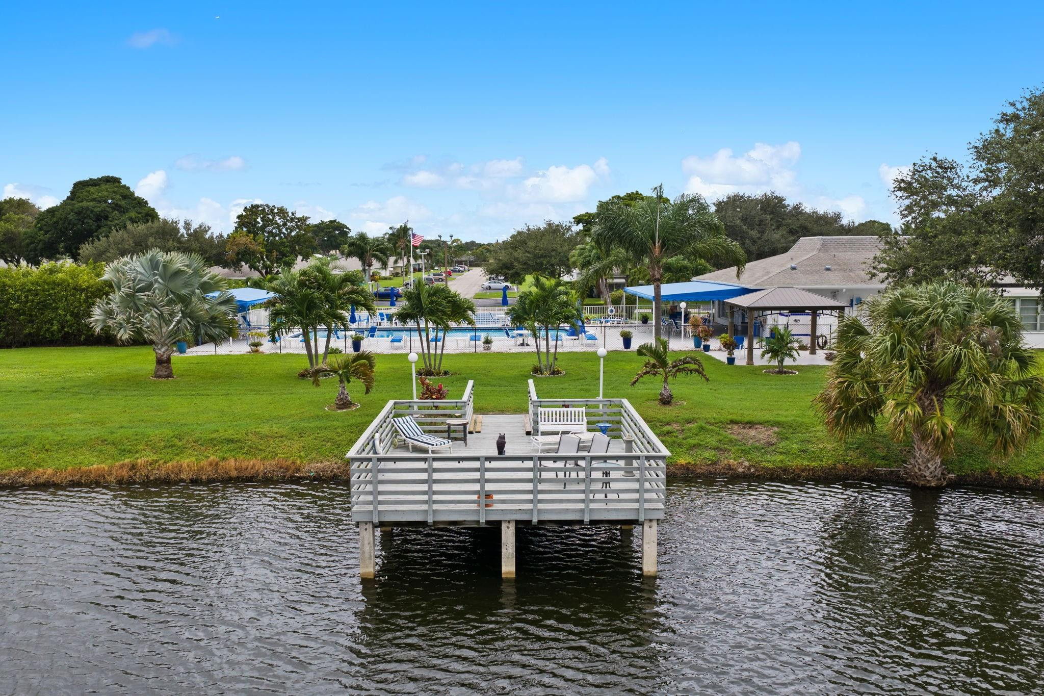152 High Point Boulevard, Unit D Delray Beach, FL 33445 - Photo 34 of 34 a view of a wooden deck with a garden