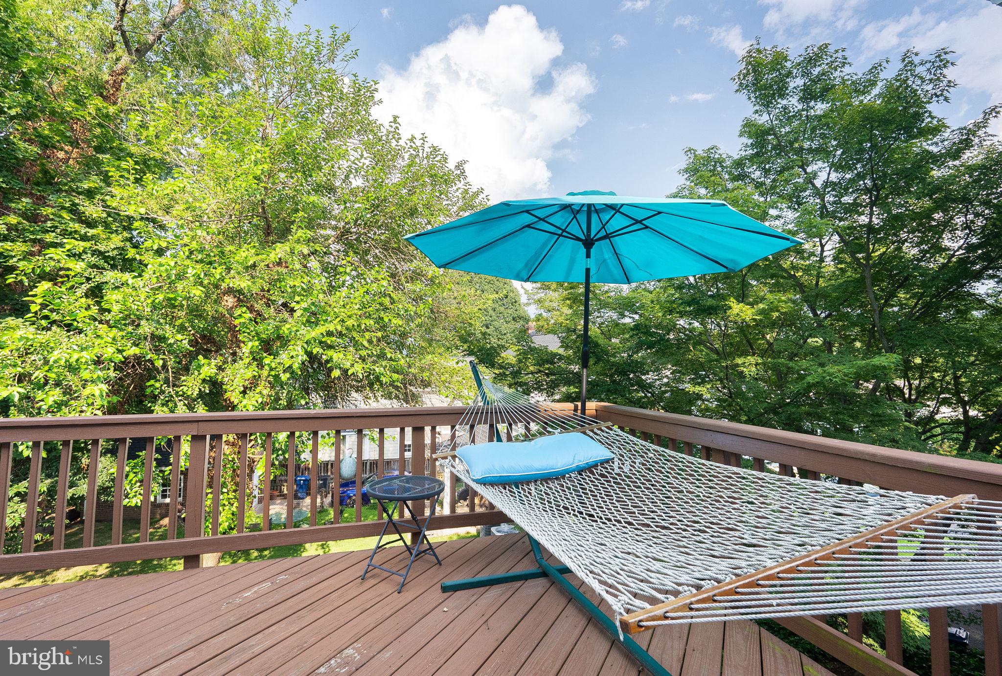 1703 Russell Road Alexandria, VA 22301 - Photo 20 of 42 a roof deck with a table and chairs under an umbrella